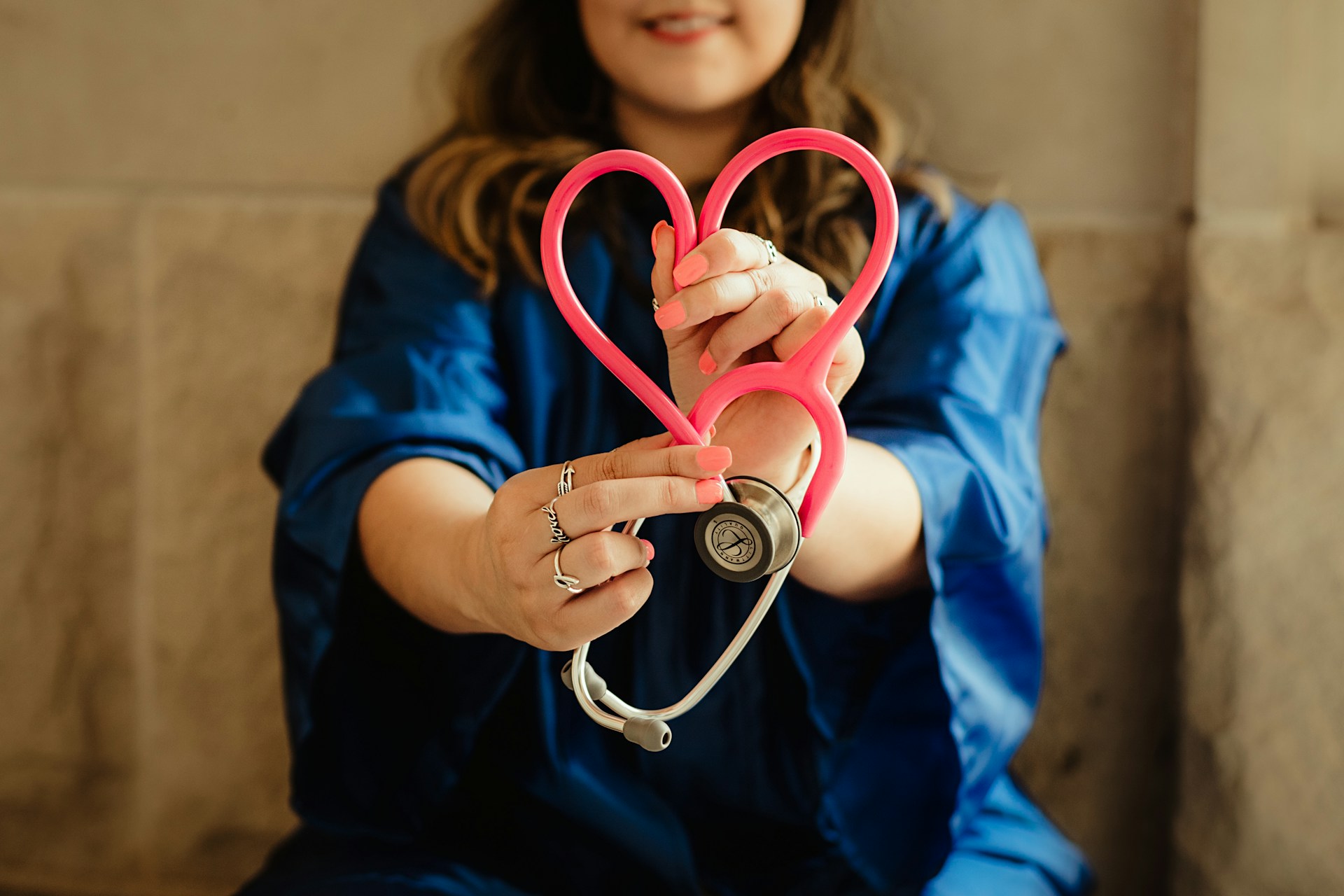 doctor for annual wellness checkup holding a stethoscope